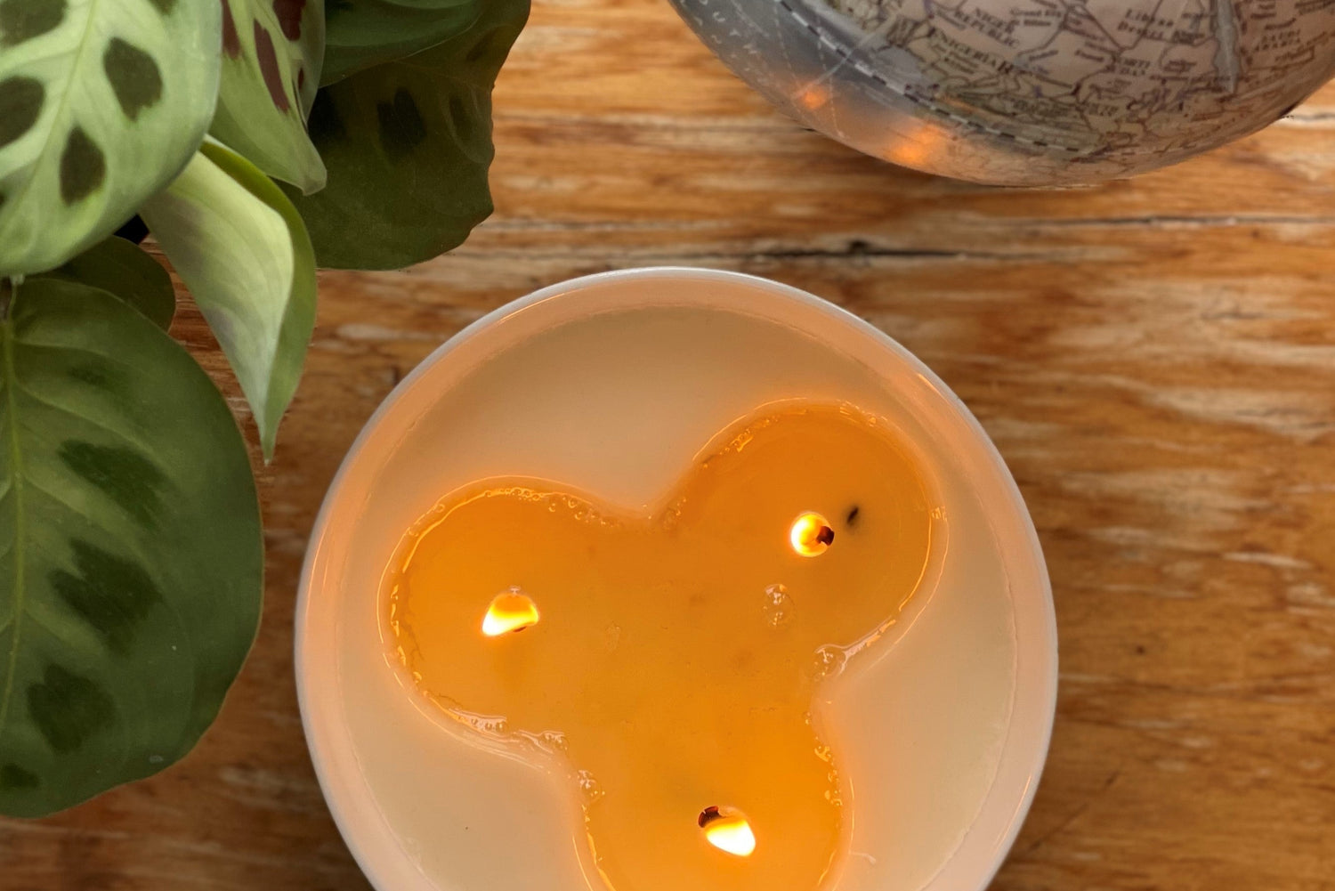 Three wick candle in a ceramic candle burning