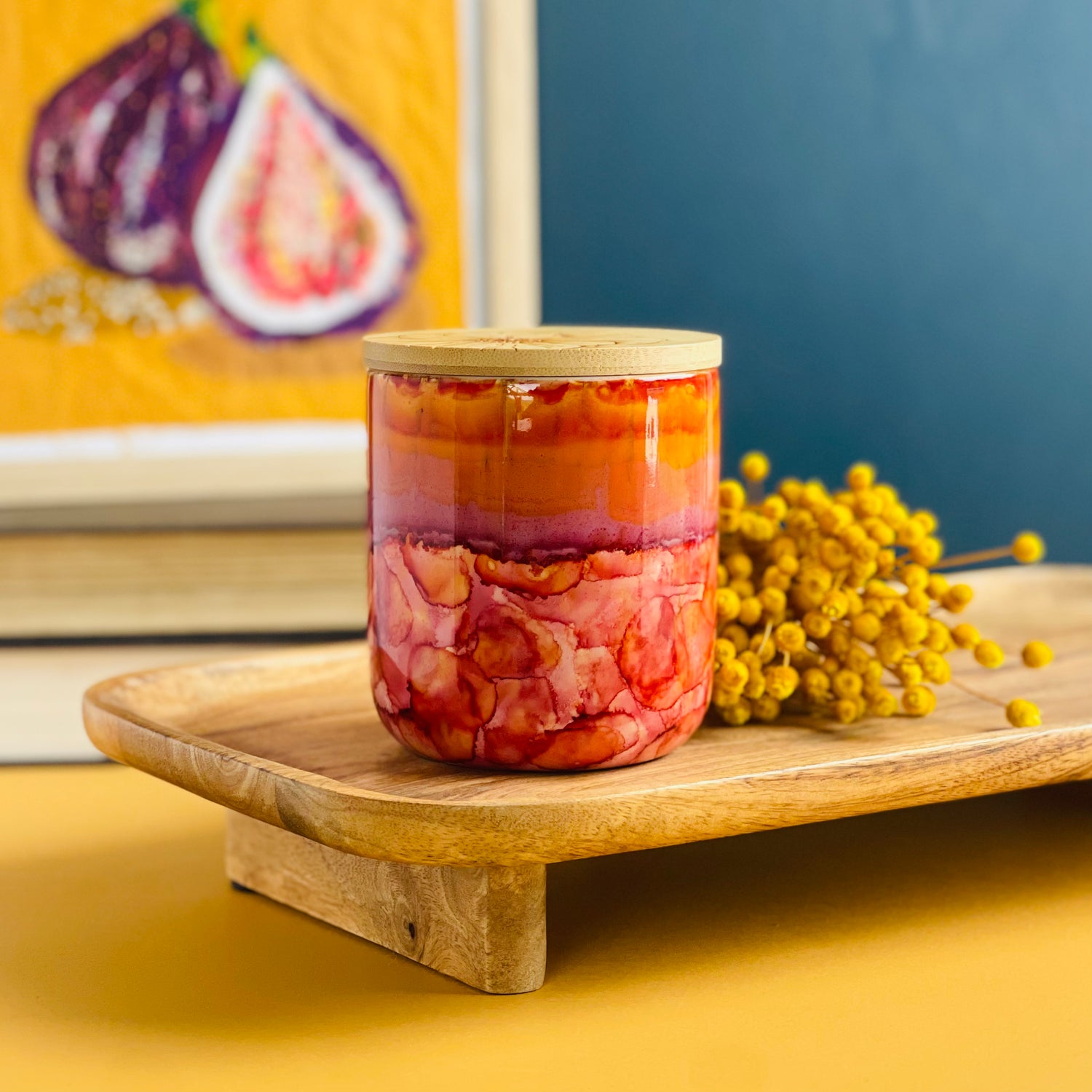 Vivid pinks, purples, and oranges surround this handpainted ceramic candle, unique candles for fall