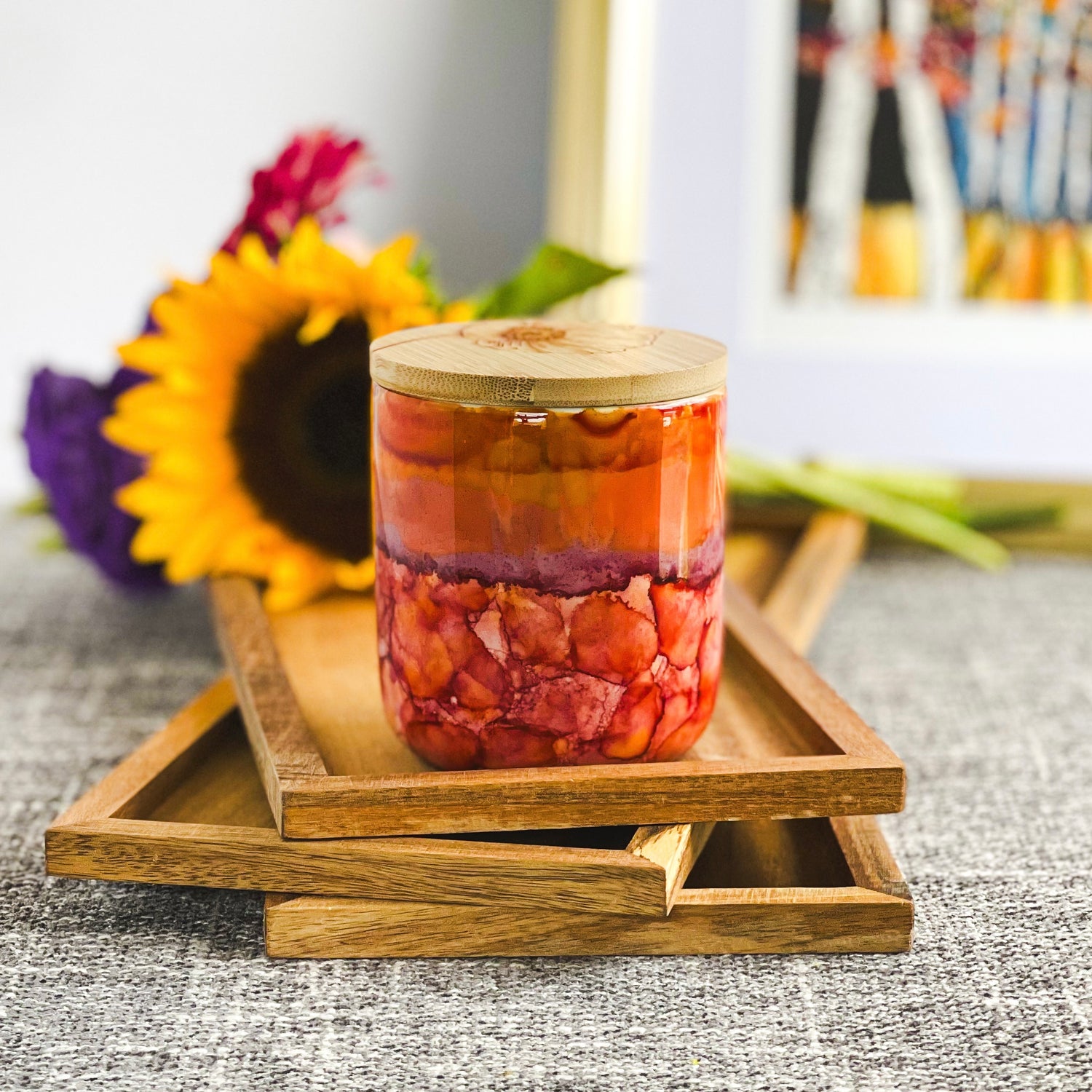 Vivid pinks, purples, and oranges surround this handpainted ceramic candle, unique candles for fall