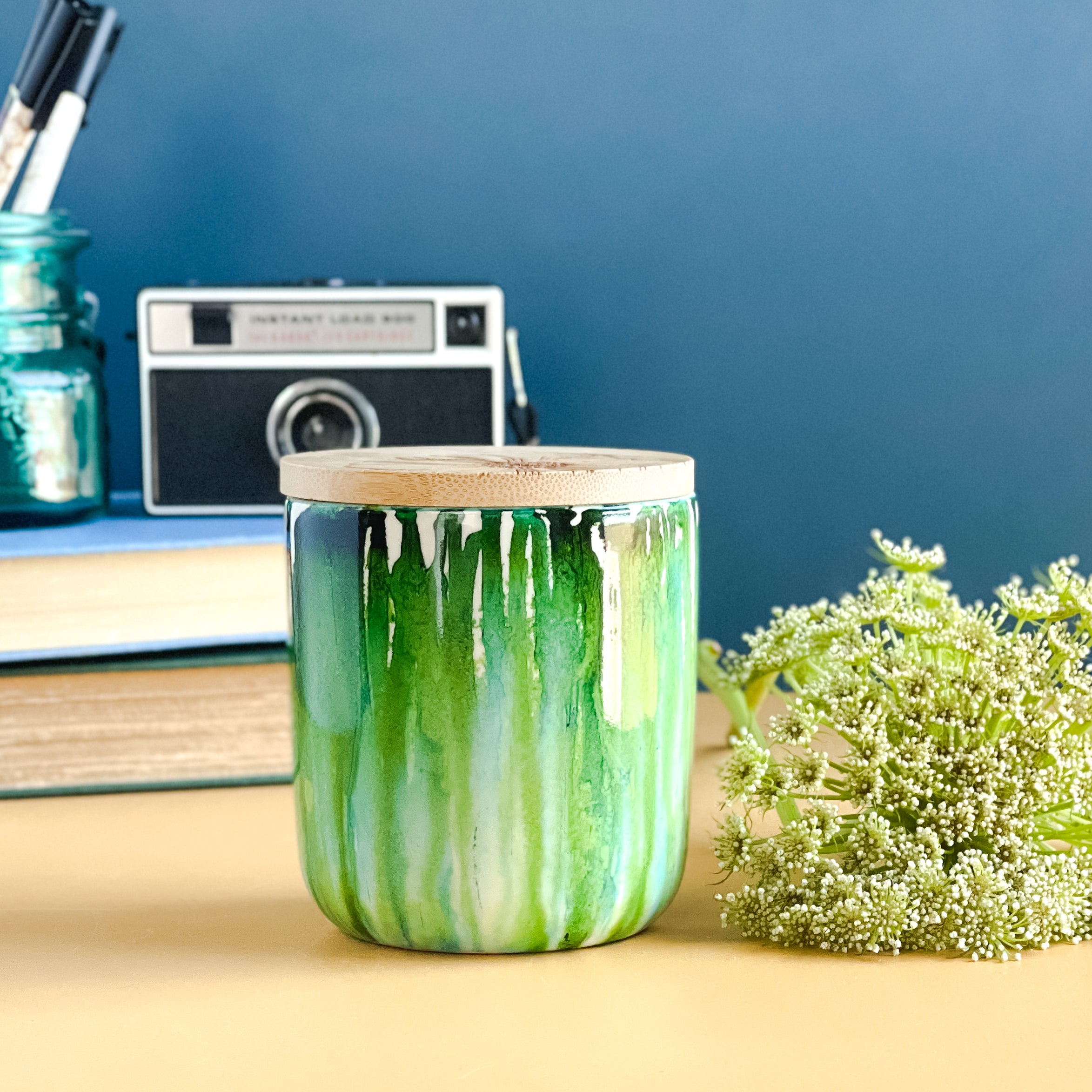 Tall, two wick ceramic soy candle handpainted in drippy shades of green