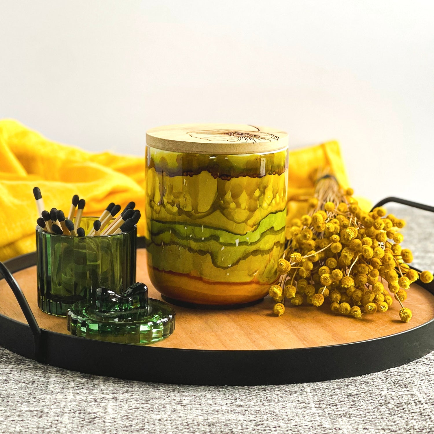 Handpainted ceramic candle in stacked shades of muted greens, golds, and amber, unique candles for fall