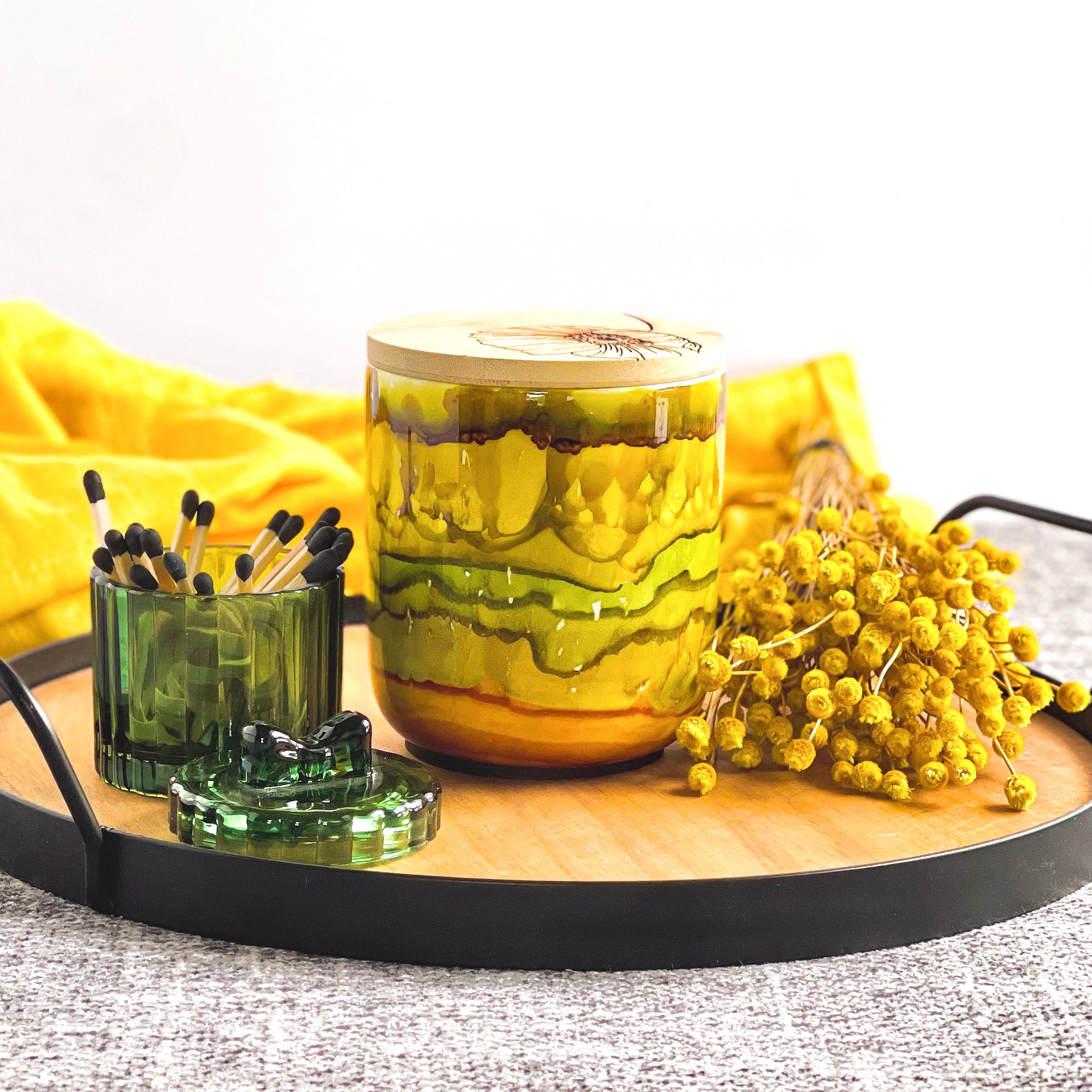 Tall, two wick ceramic candle handpainted in shades of green, gold, honey, and amber