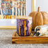 Handpainted ceramic candle in shades of plum and violet accented with golden yellow, unique candles for fall