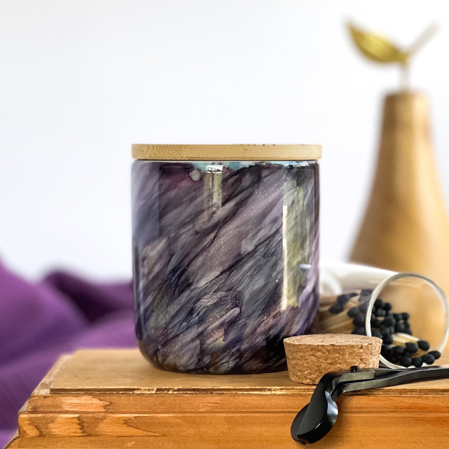Tall, two wick ceramic soy candle handpainted in swashes of shimmery deep purple