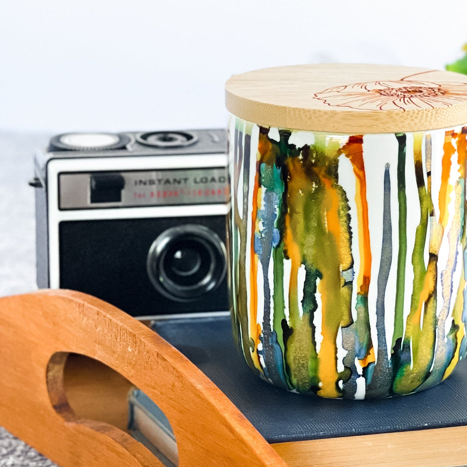 Tall, two wick ceramic soy candle handpainted in blues, greens, yellows and shimmery gold