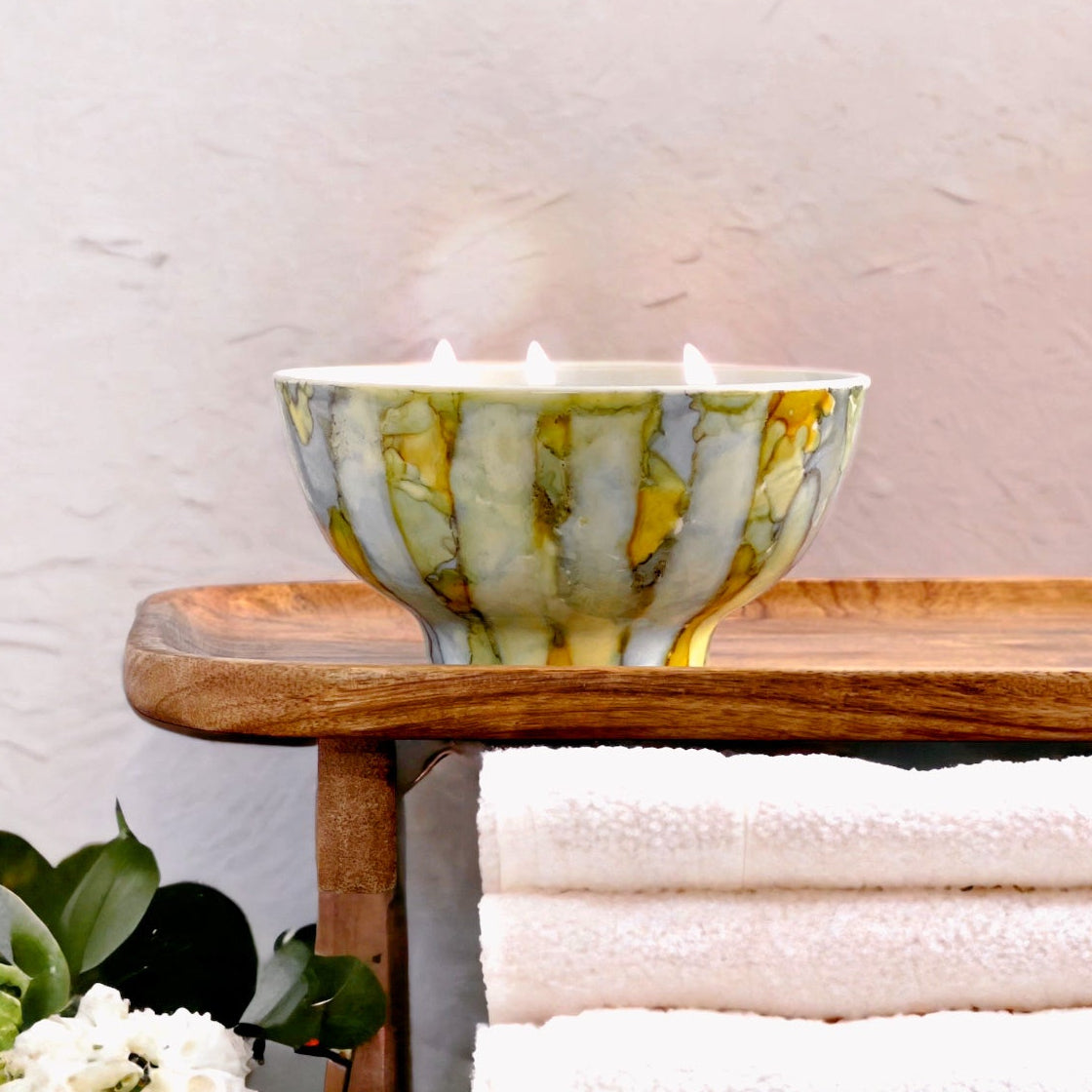 Handpainted ceramic candle in soft shades of blue, yellow and green