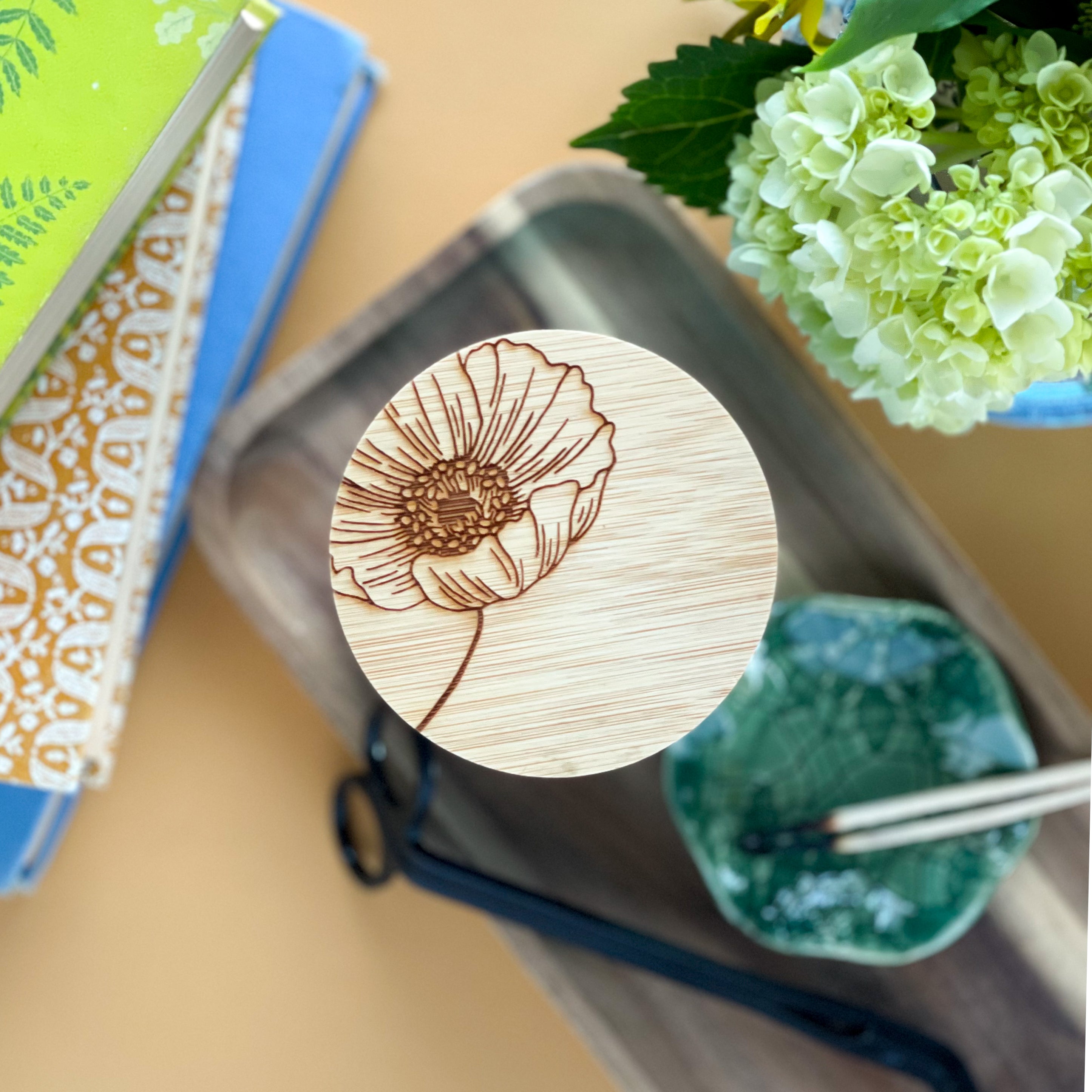 Top view of the laser engraved floral lid on a tall ceramic candle