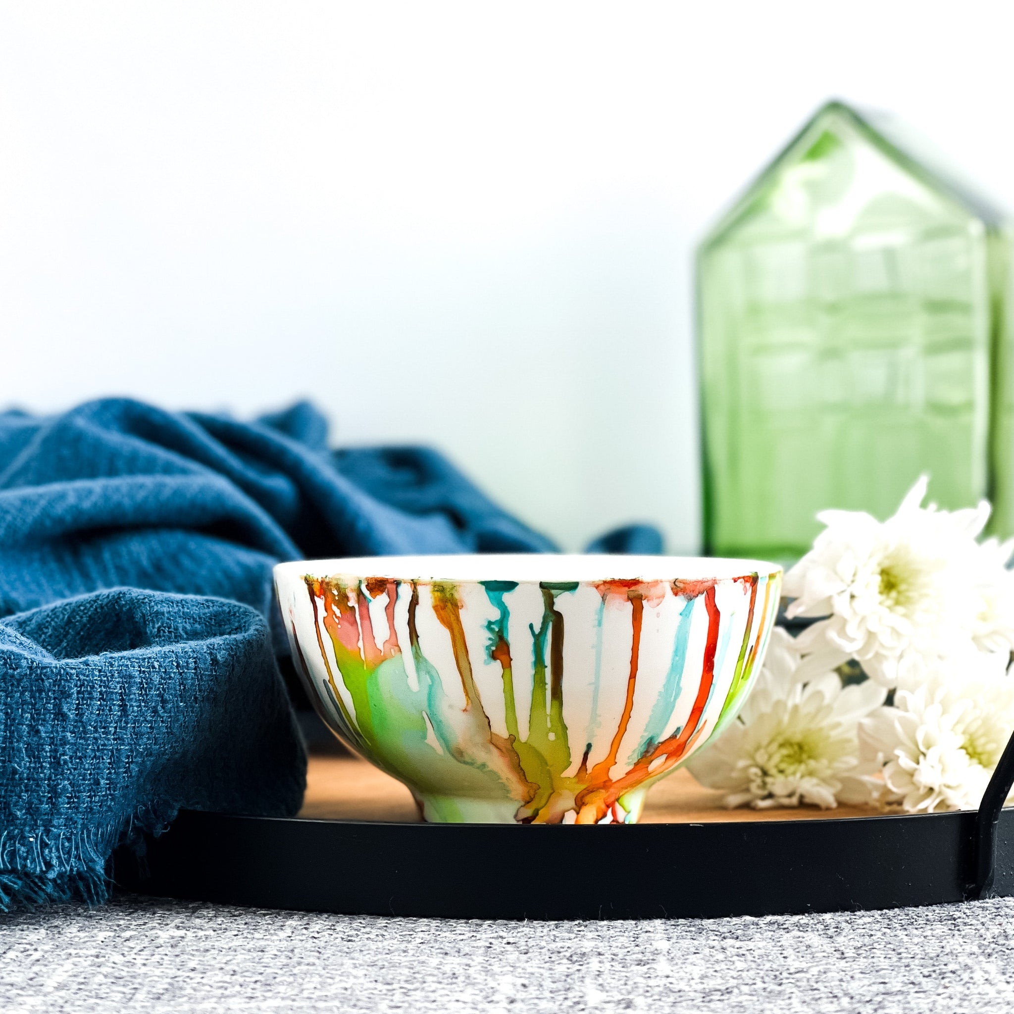 Ceramic soy candle handpainted in bright reds, yellows, teals, and greens