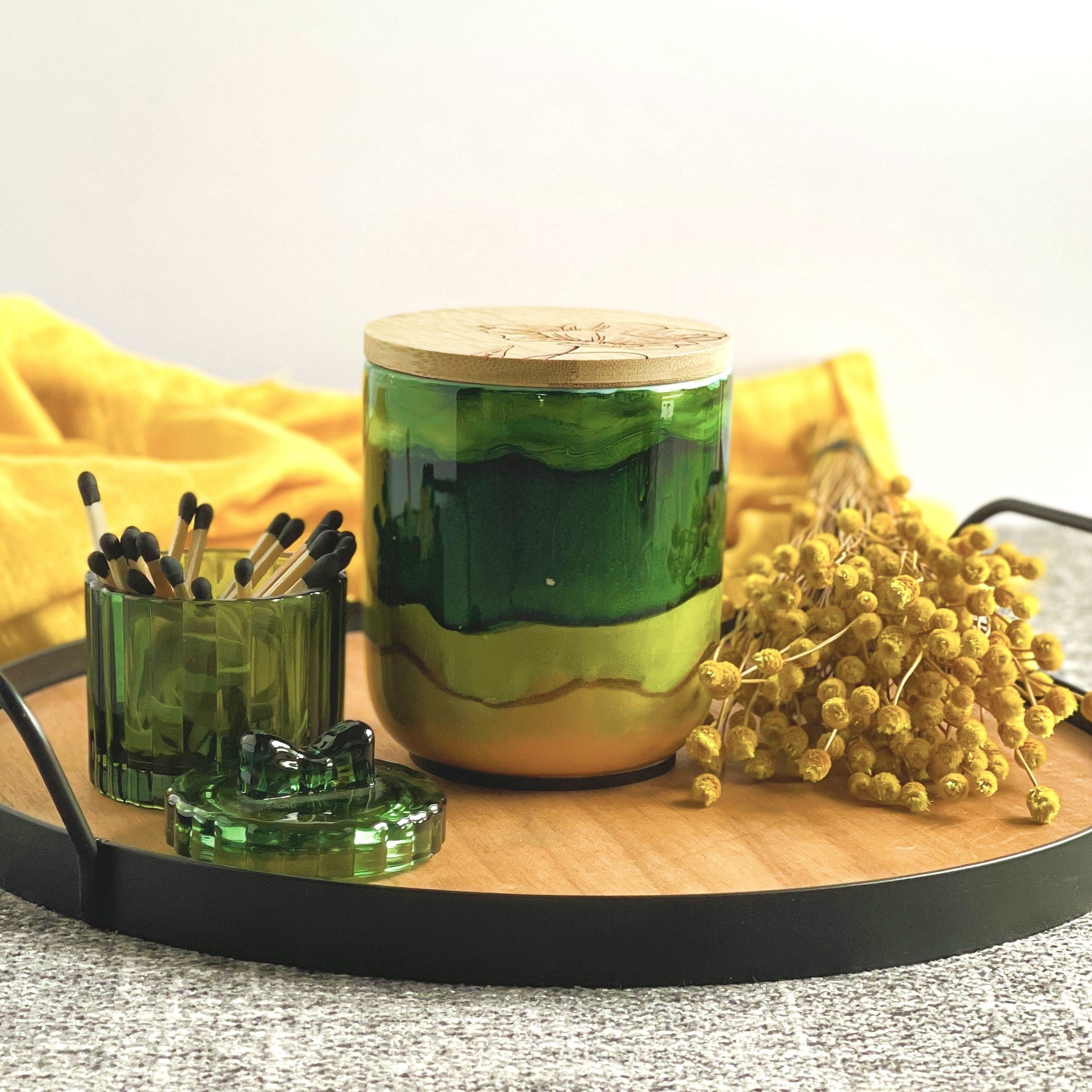 A wide deep green band with soft green and muted yellow surround this handpainted ceramic candle, unique candles for fall