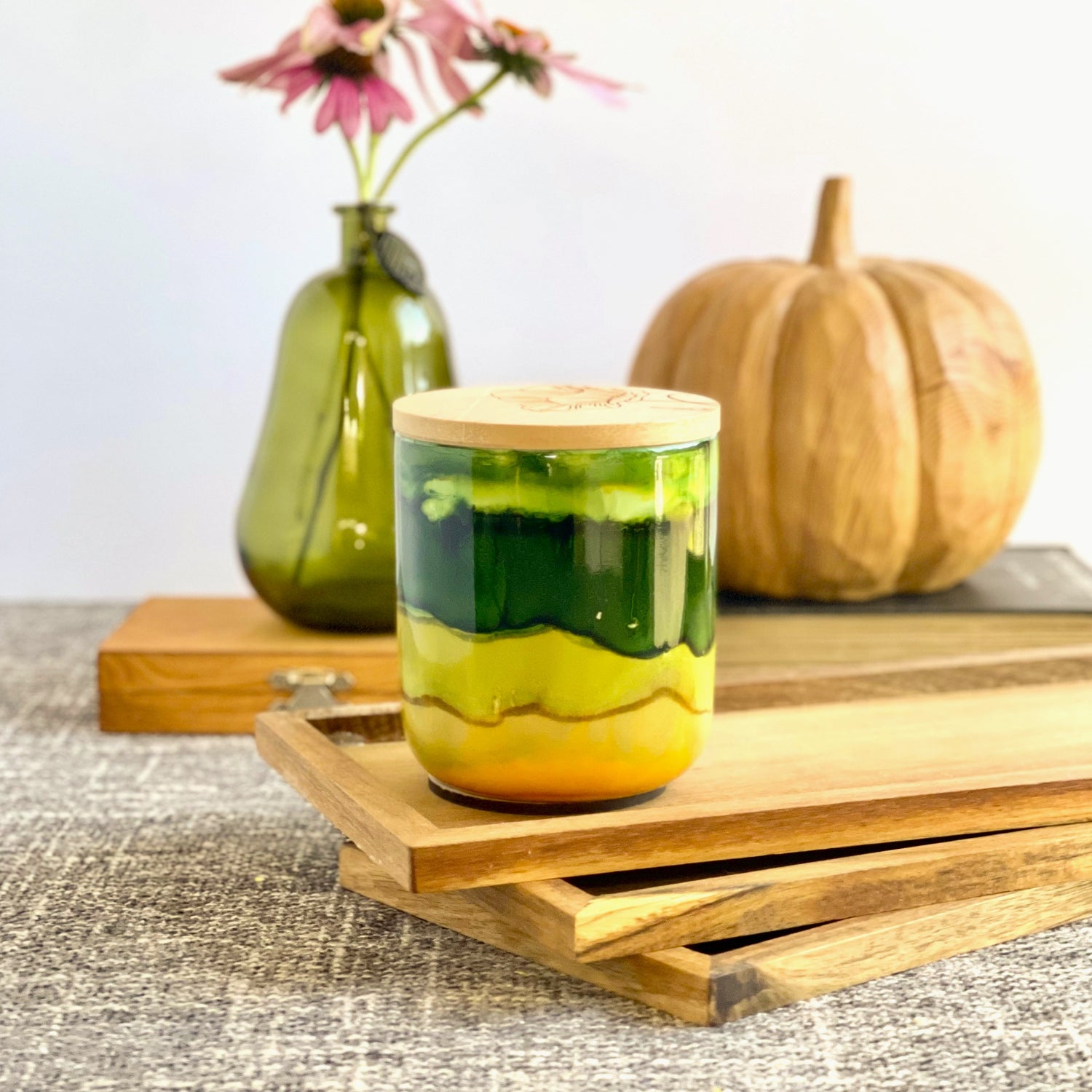 A wide deep green band with soft green and muted yellow surround this handpainted ceramic candle, unique candles for fall