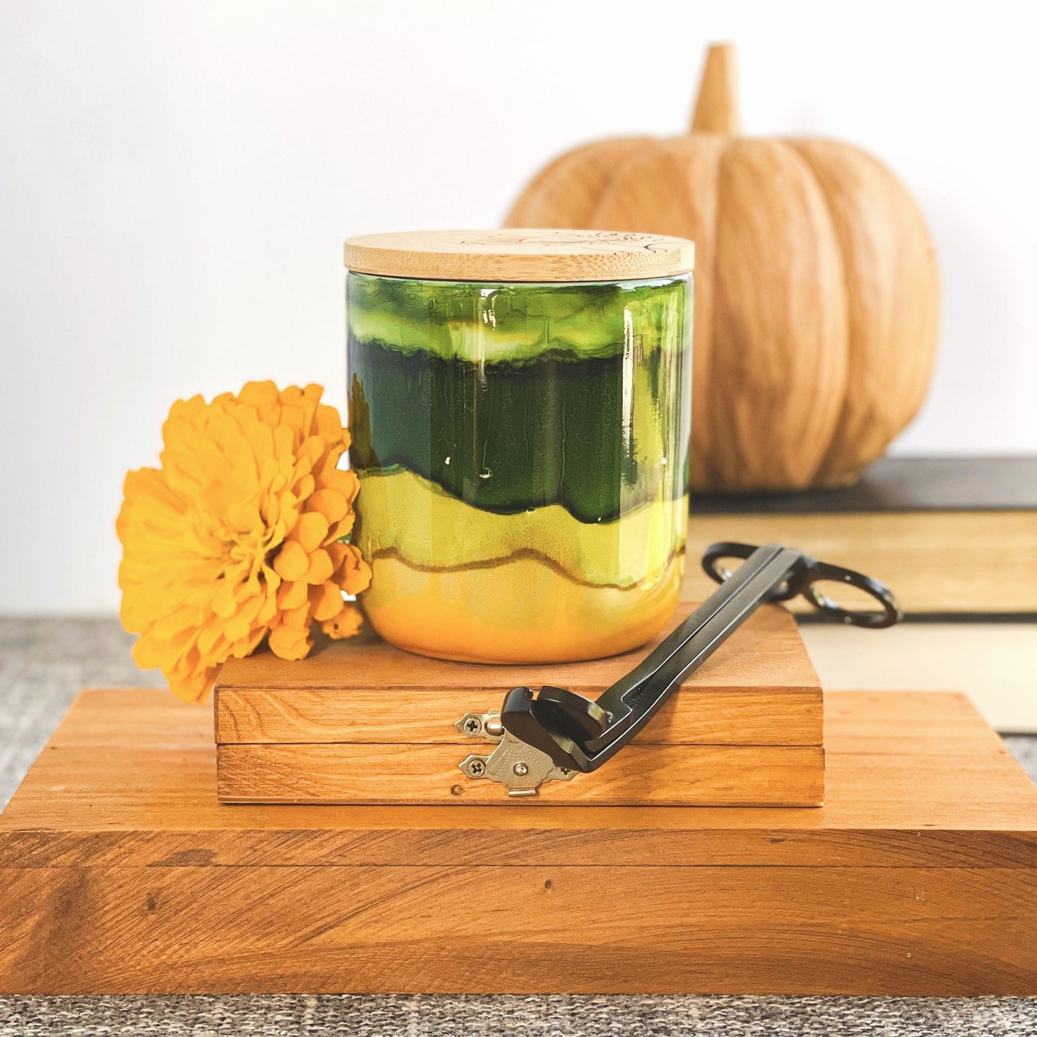 A wide deep green band with soft green and muted yellow surround this handpainted ceramic candle, unique candles for fall