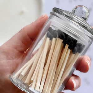 black tipped matches in a glass jar