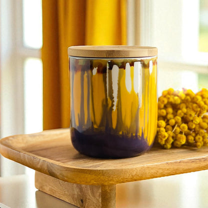 Tall, two wick ceramic candle handpainted in softly blended warm yellows and muted purples