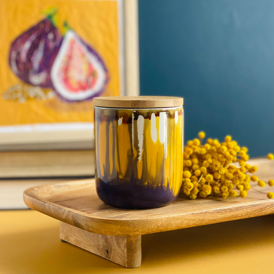 Tall, two wick ceramic candle handpainted in softly blended warm yellows and muted purples