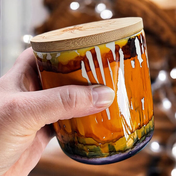 Burnt orange, gold, and purple hand painted ceramic candle with bamboo lid