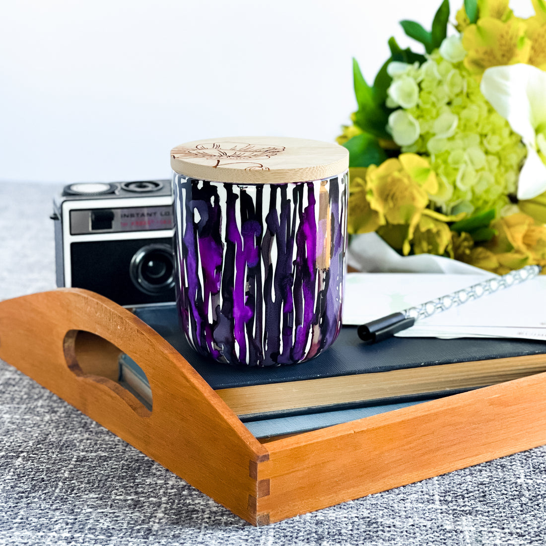 Tall, two wick ceramic soy candle handpainted in multiple shades of purple