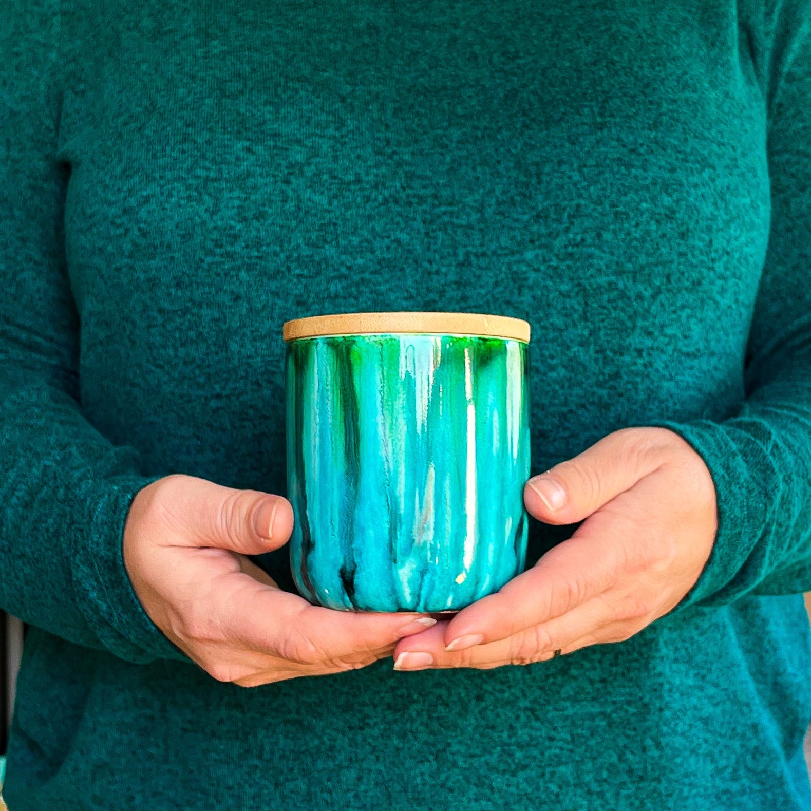Tall, two wick ceramic soy candle handpainted in vibrant shades of teal