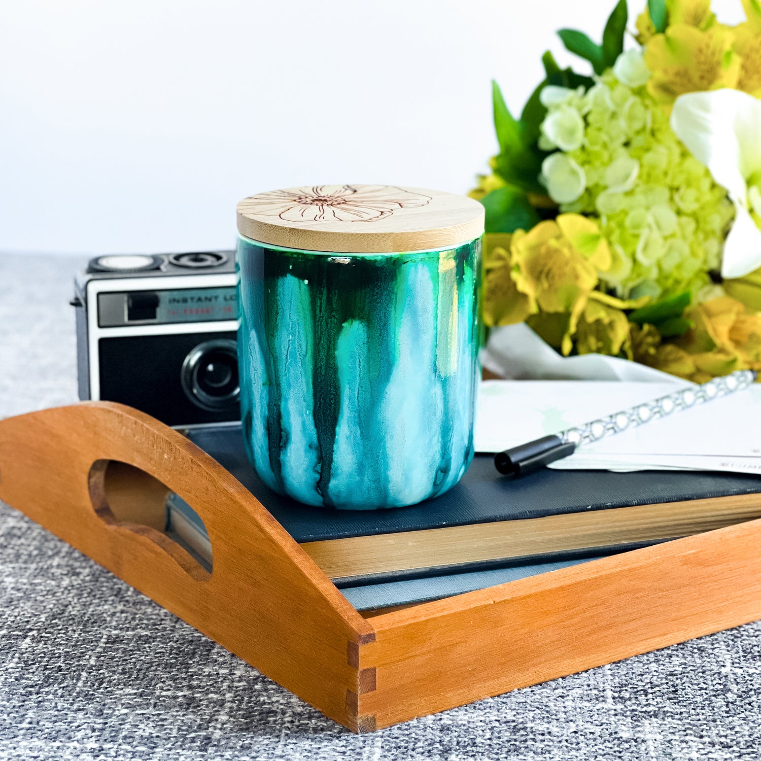 Tall, two wick ceramic soy candle handpainted in vibrant shades of teal
