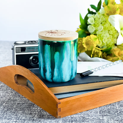Tall, two wick ceramic soy candle handpainted in vibrant shades of teal