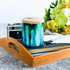 Tall, two wick ceramic soy candle handpainted in vibrant shades of teal