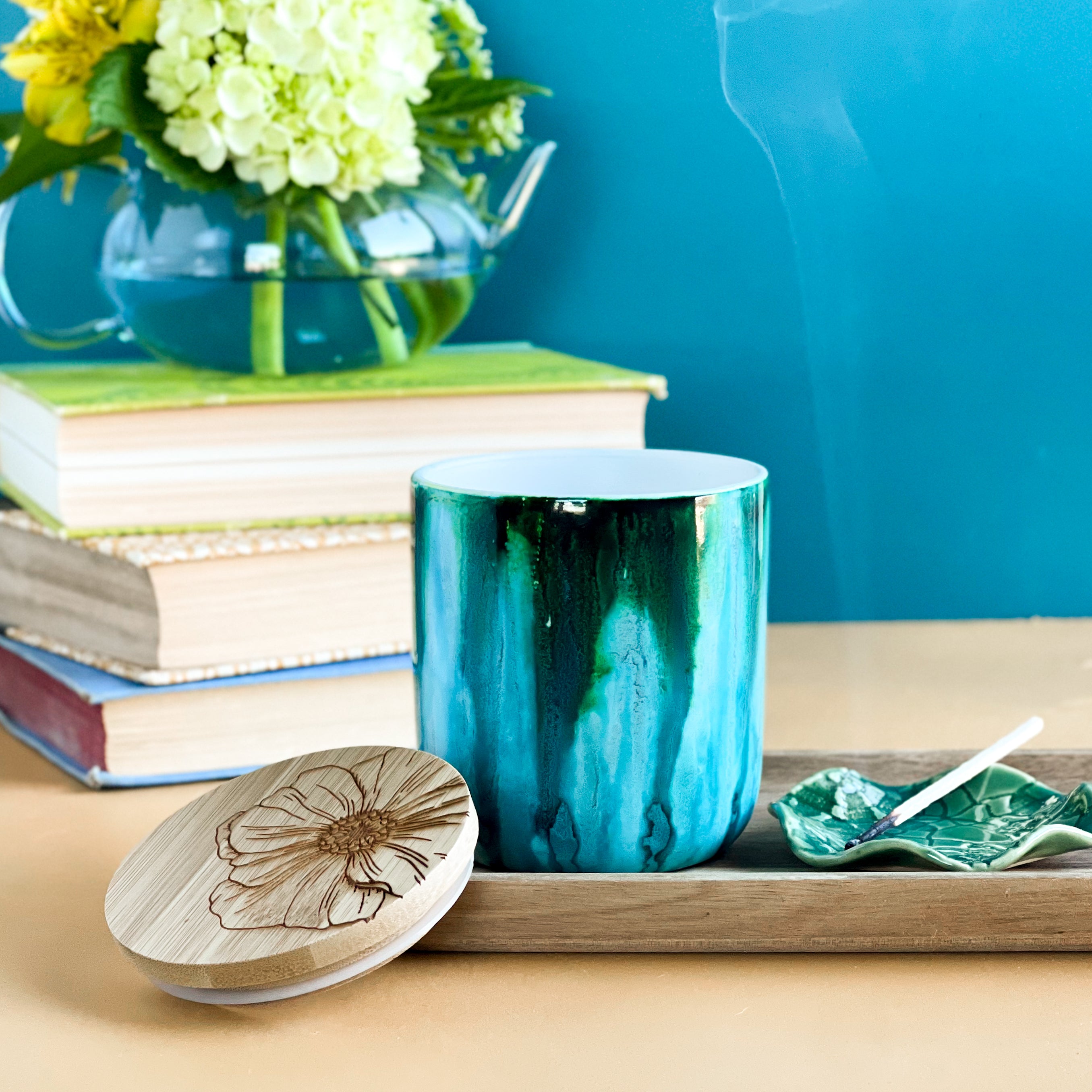 Tall, two wick ceramic soy candle handpainted in vibrant shades of teal