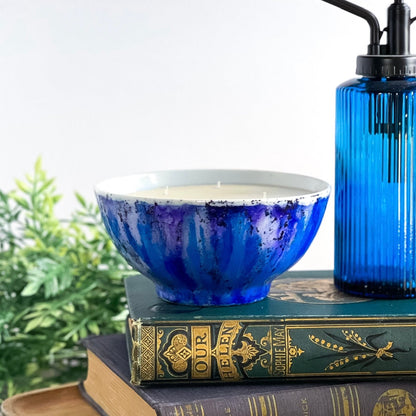 Handpainted, three wick ceramic candle in bold blues and a touch of purple