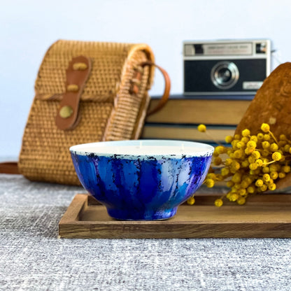 Handpainted, three wick ceramic candle in bold blues and a touch of purple