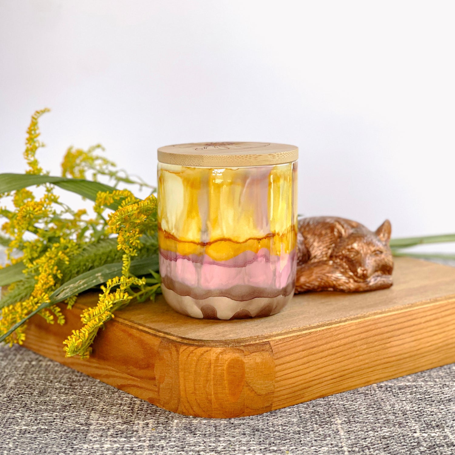 Tall, two wick ceramic soy candle handpainted in layers of gray, soft pink, amber, and yellow