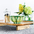Handpainted, three wick ceramic candle in muted layers of green and yellow