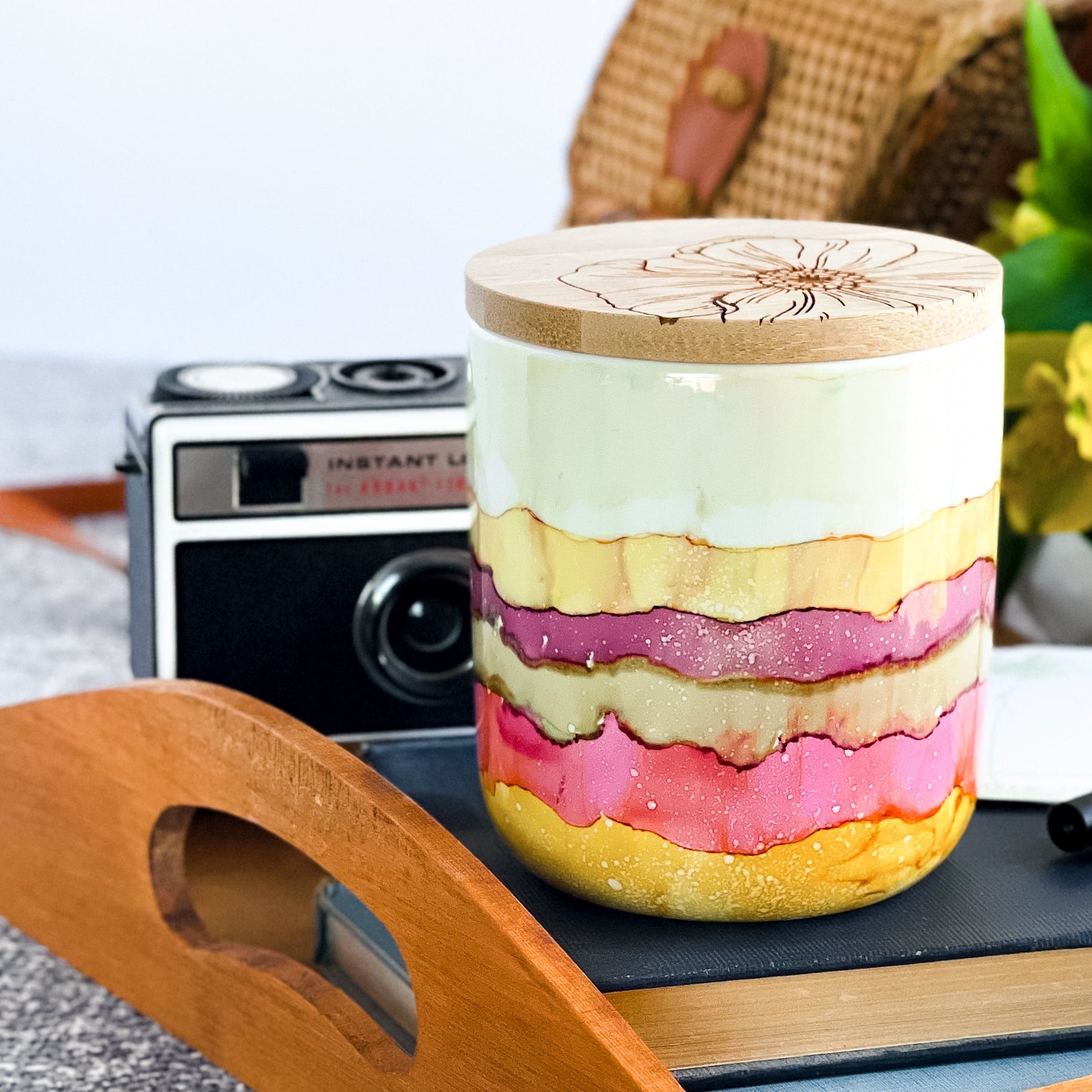 Tall, two wick ceramic soy candle handpainted in bands of cream, raspberry, pale green and warm yellow