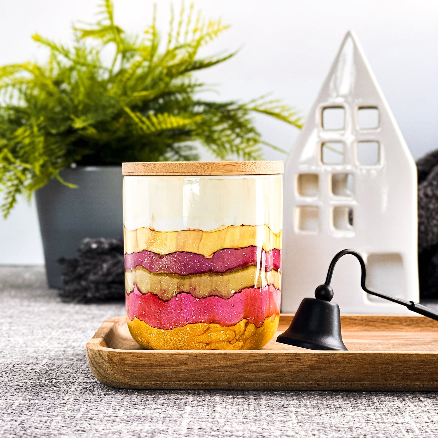 Tall, two wick ceramic soy candle handpainted in bands of cream, raspberry, pale green and warm yellow