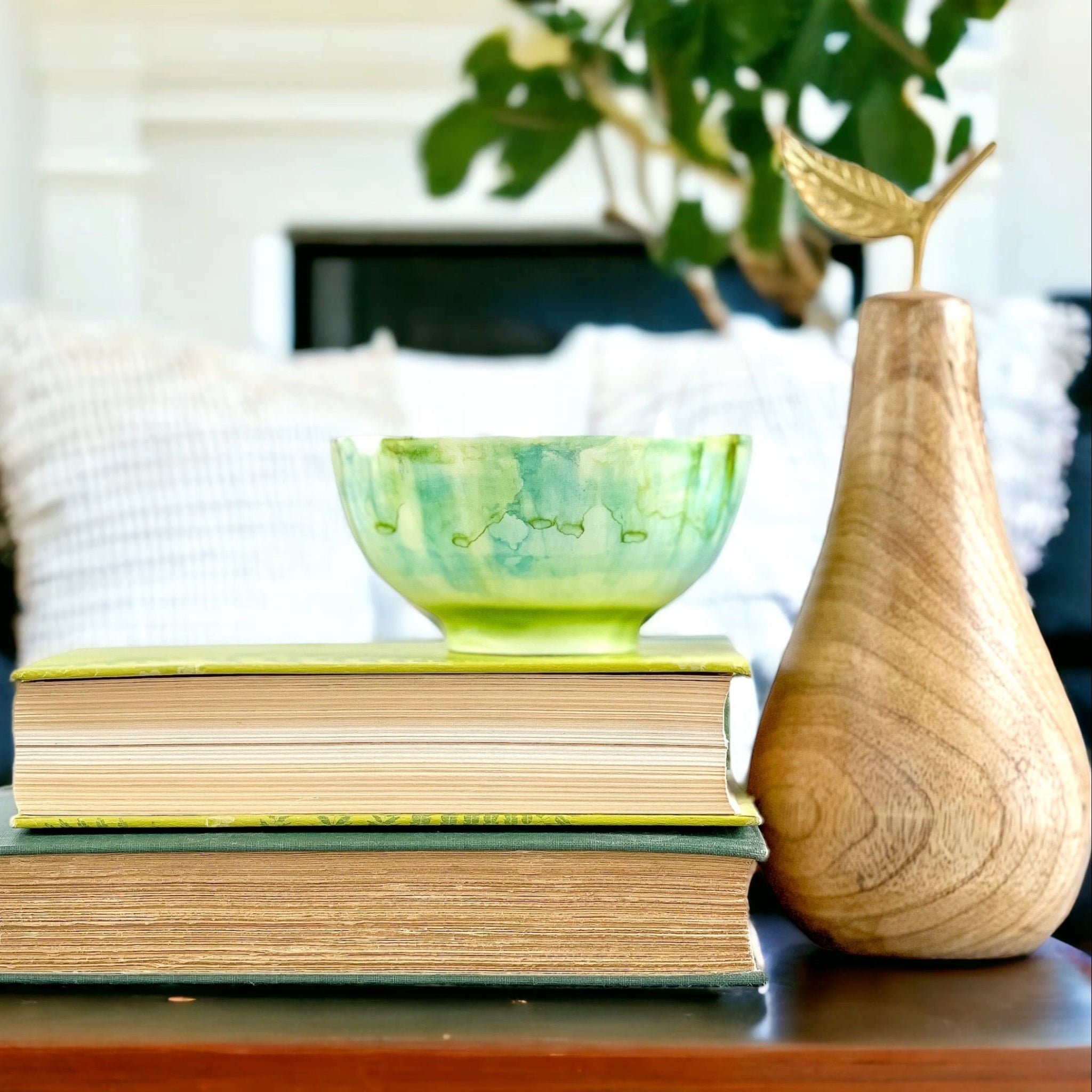 Ceramic soy candle handpainted in bright greens and teals