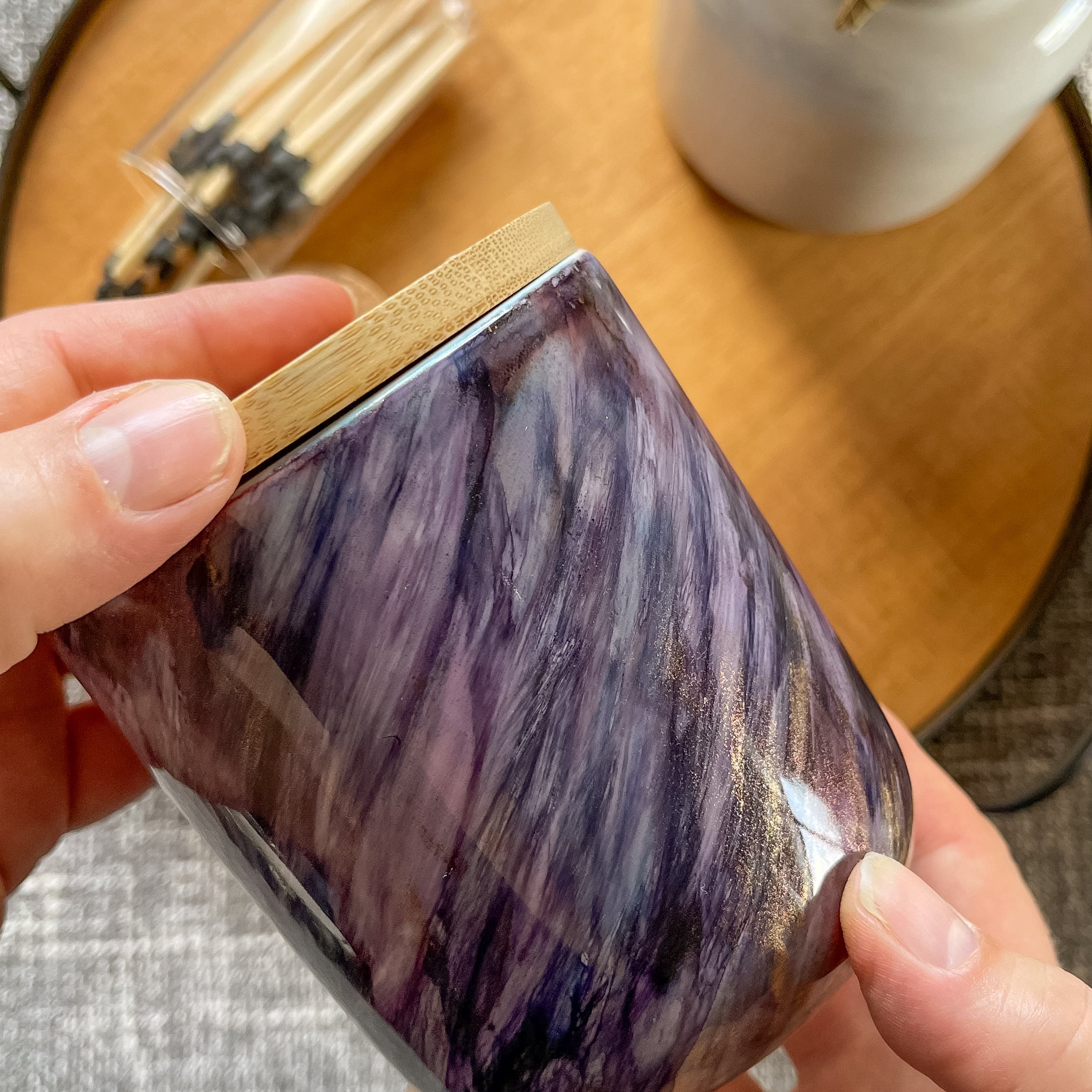 Tall, two wick ceramic soy candle handpainted in swashes of shimmery deep purple