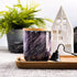 Tall, two wick ceramic soy candle handpainted in swashes of shimmery deep purple