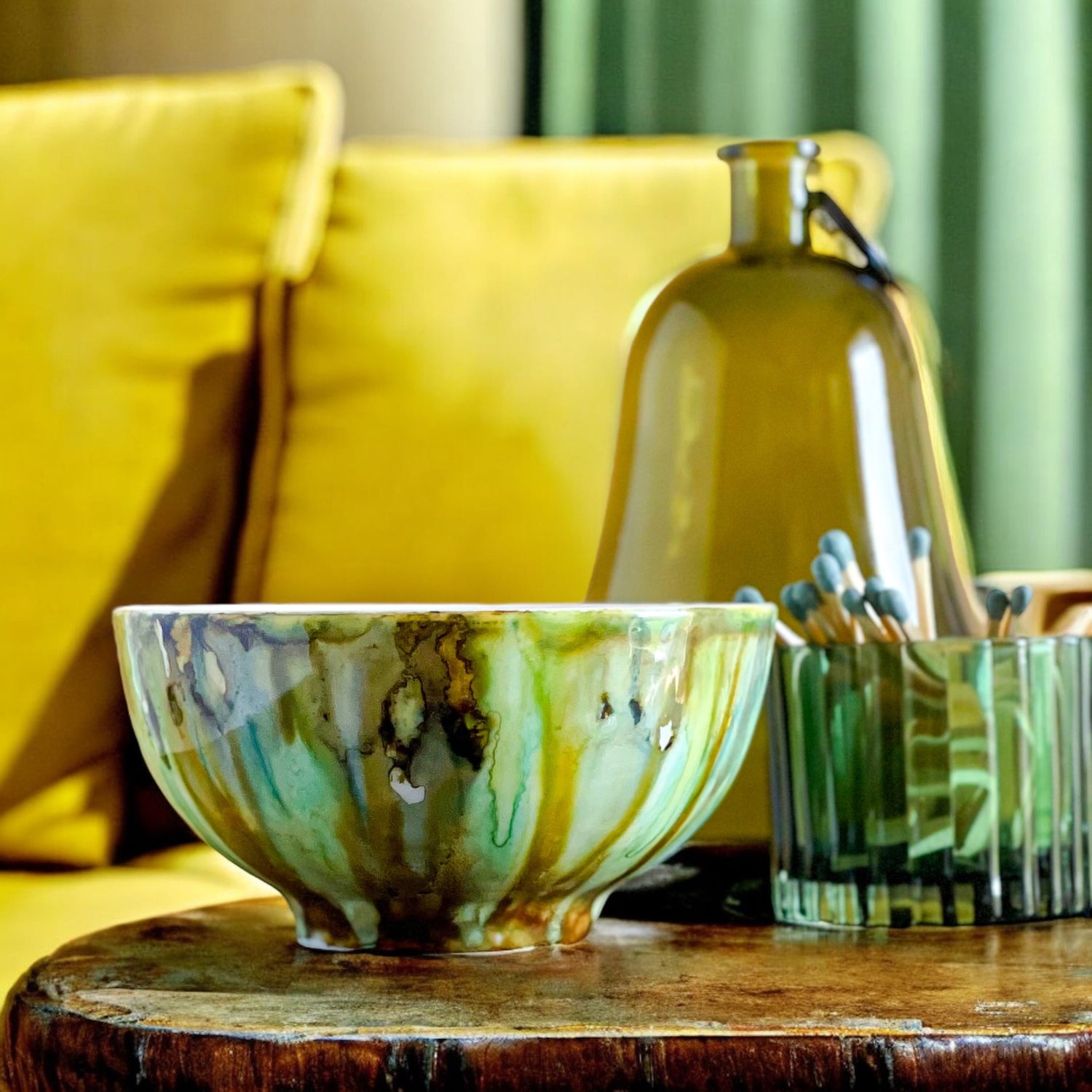 Handpainted ceramic candle in shades of jade green and espresso brown