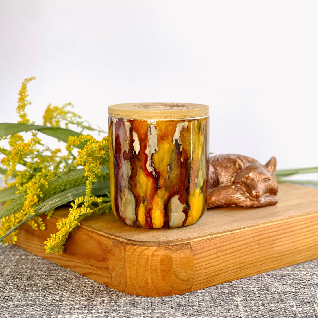 Handpainted ceramic candle in multiple shades of rich browns a touch of cinnamon color and ample golden yellow, unique candles for fall