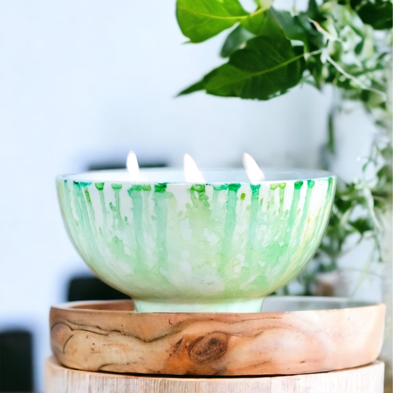 Lit ceramic candle handpainted in soft teal and white