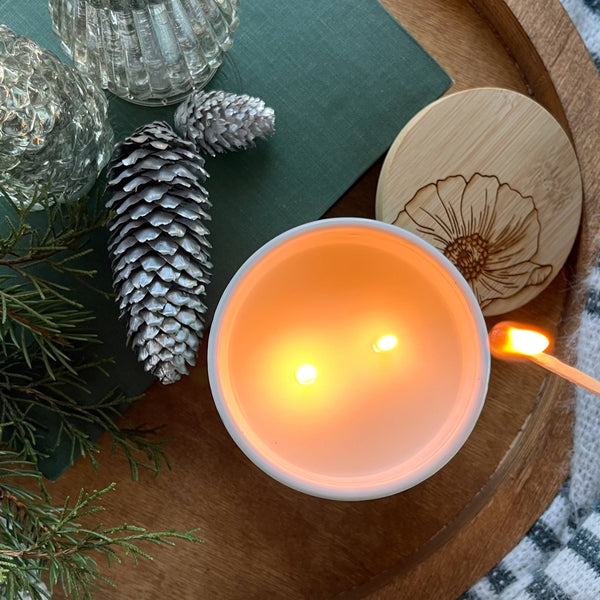 Top view of a tall ceramic candle lit