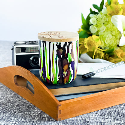 Tall, two wick ceramic soy candle handpainted in bright greens and deep purples
