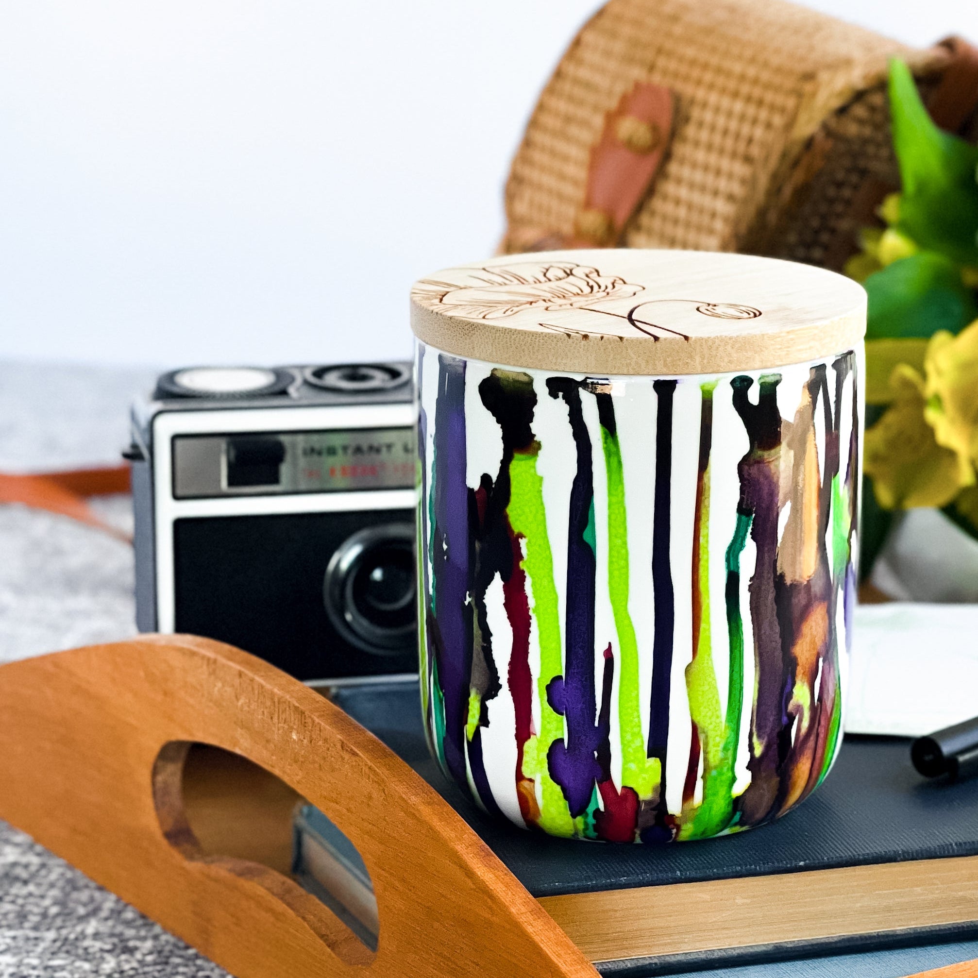 Tall, two wick ceramic soy candle handpainted in bright greens and deep purples
