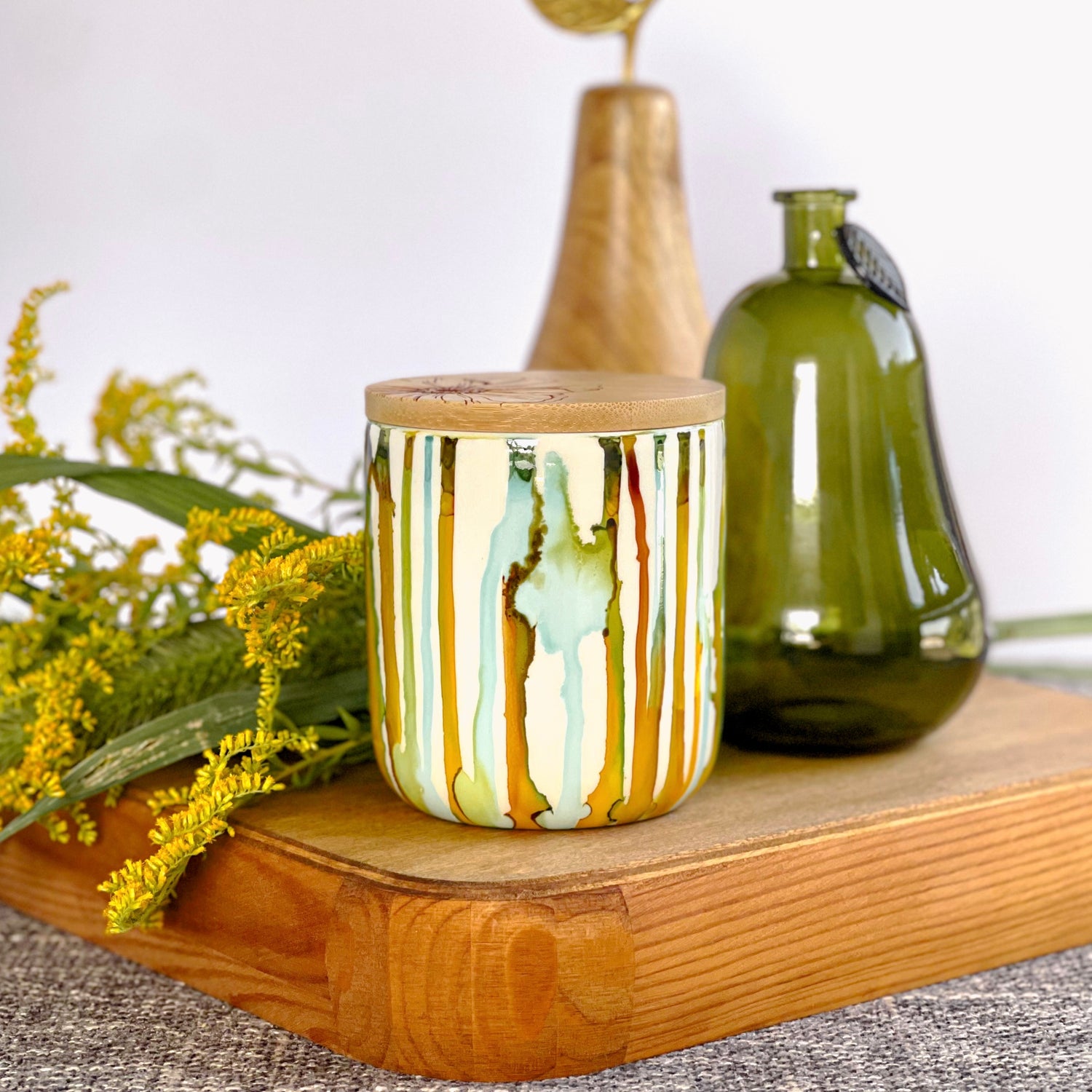 Tall, two wick ceramic candle handpainted in drippy soft teals and deep yellows