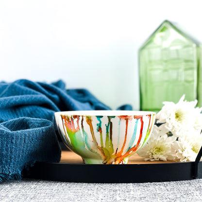 Ceramic soy candle handpainted in bright reds, yellows, teals, and greens