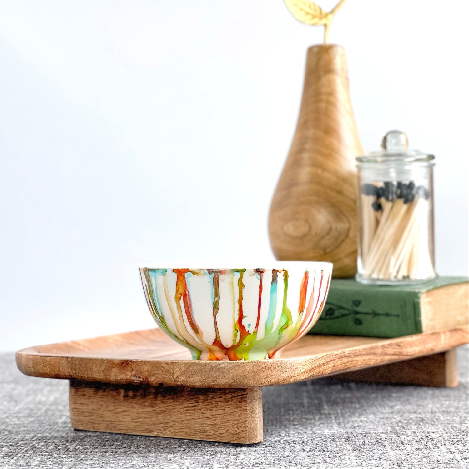 Ceramic soy candle handpainted in vivid reds, teals, greens, and yellows