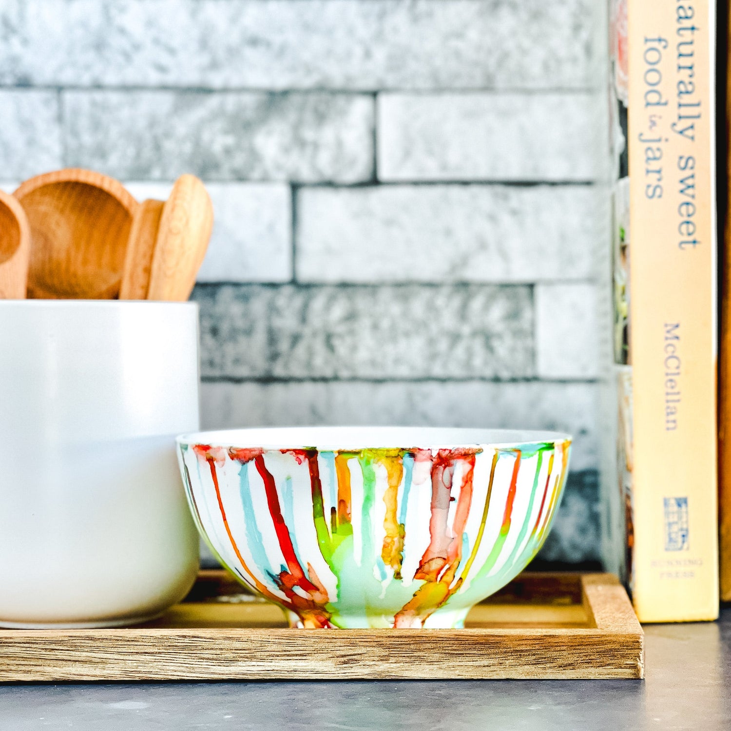 Ceramic soy candle handpainted in vivid shades of green, teal, red and yellow