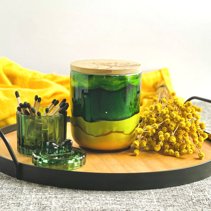 Tall, two wick ceramic candle handpainted in bands of mossy and forest greens with a base of warm yellow
