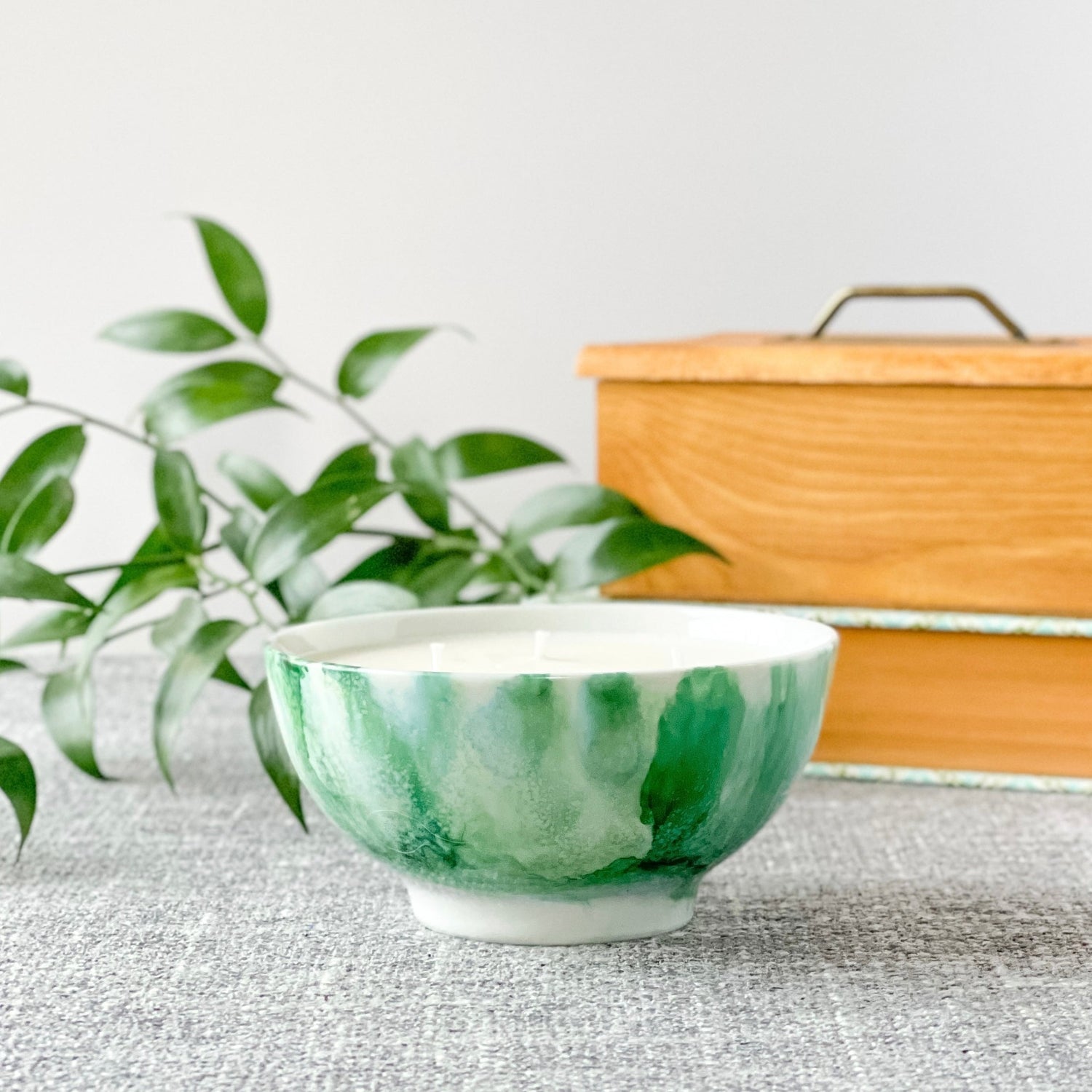 Ceramic three wick soy candle handpainted in jade green with a white base