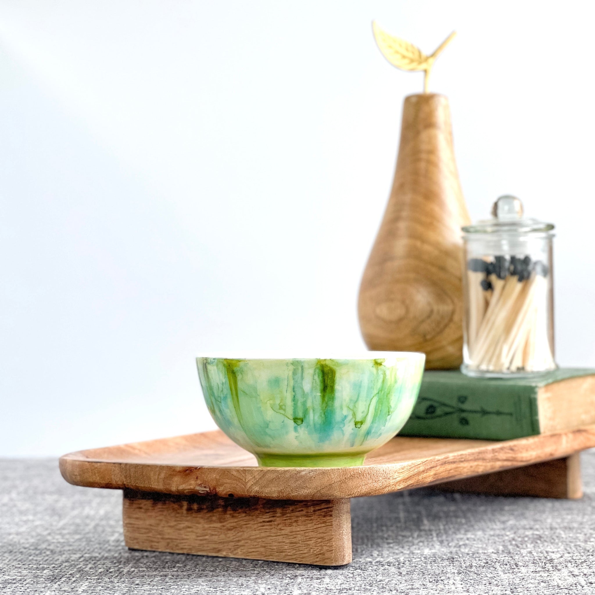 Ceramic soy candle handpainted in bright shades of green and teal