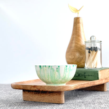 Handpainted ceramic candle in soft teal and white