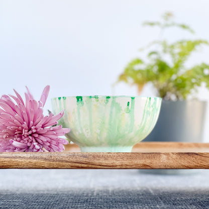 Handpainted ceramic candle in soft teal and white